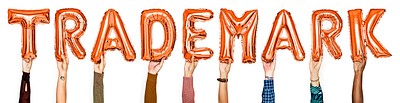 Orange balloon letters forming the word trademark<br />