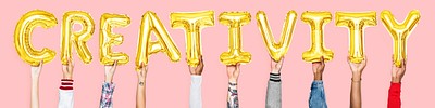 Hands holding creativity word in balloon letters