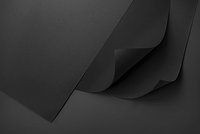 Curled black chart paper on a dark gray background