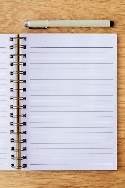 Blank plain white notebook page with a pen mockup