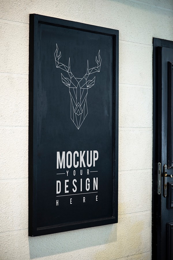 Free PSD mockup of a poster displayed on a shop window.