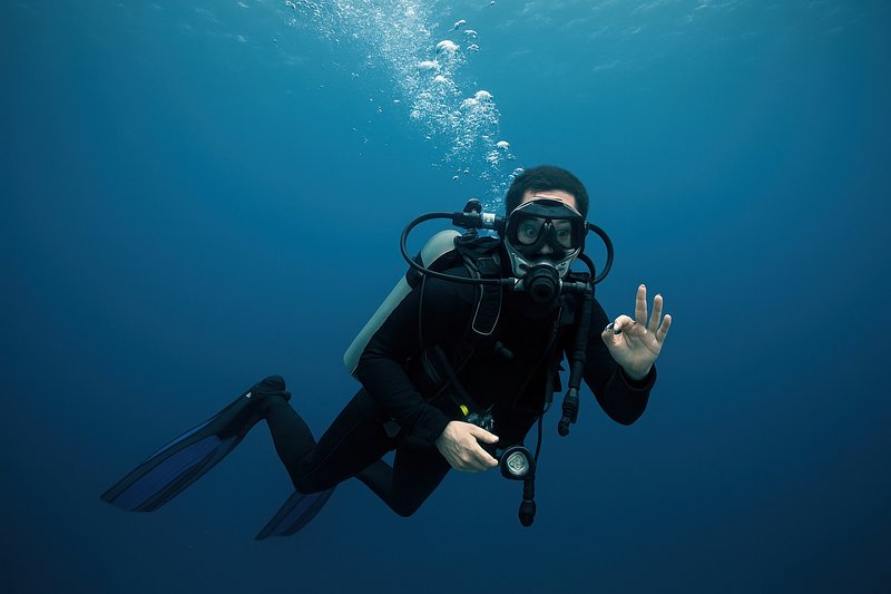 Scuba diver underwater signaling okay.