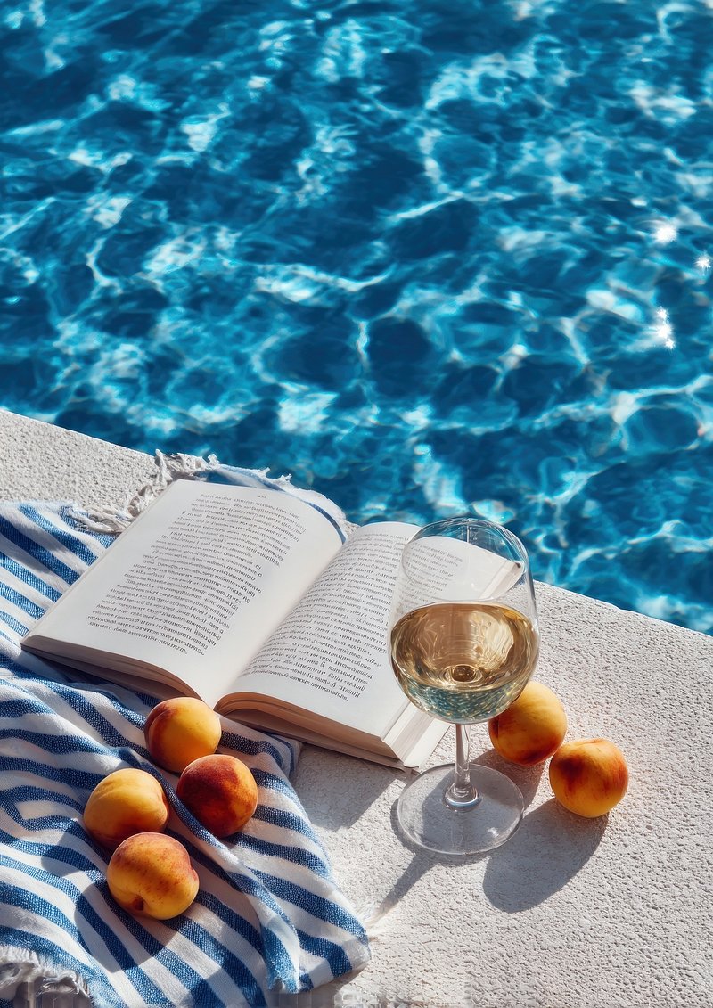 Aesthetic summer scene poolside book outdoors peaches.