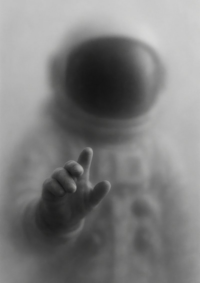 Mysterious astronaut reaching out.