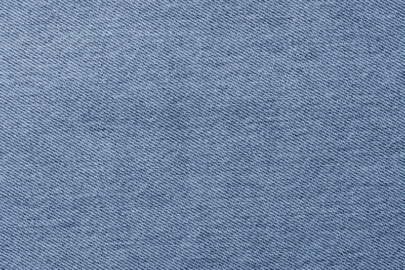Jeans background. Light blue denim fabric texture close up. Stock Photo