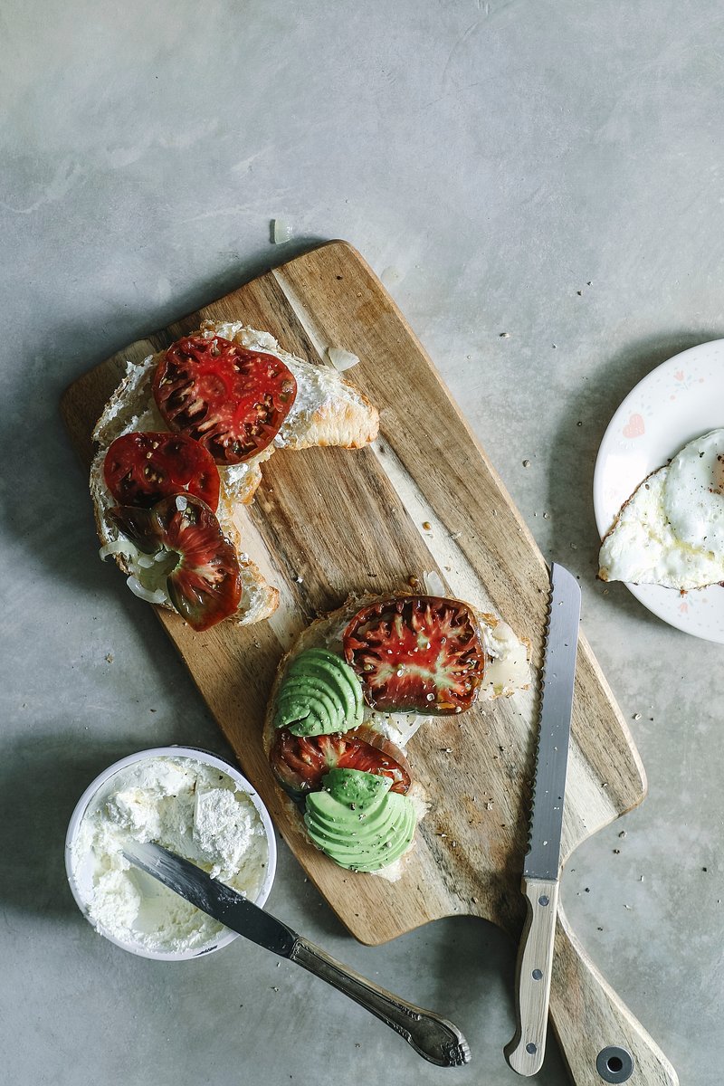 Premium AI Image  Avocado toast on a wooden cutting board with a knife and  a knife next to it.