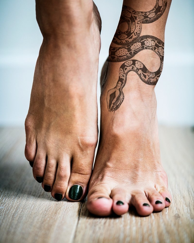 Cute snake tattoo located on the foot