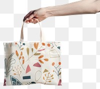 PNG Hand holding patterned tote bag