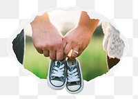 Couple png holding baby shoes sticker, parenthood photo in ripped paper badge, transparent background