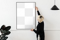 Png mockup woman hanging picture frame, home decoration, transparent design