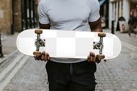 Png man holding skateboard mockup, transparent design