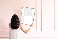 Picture frame png mockup, woman decorating wall, transparent design