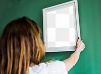 Picture frame png mockup, woman decorating wall, transparent design