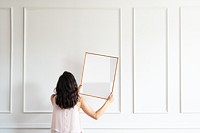 Picture frame png mockup, woman decorating wall, transparent design