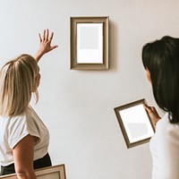 Picture frame png mockup, women decorating wall, transparent design