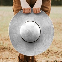 Woman holding a wide brim straw hat png