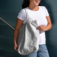 Transparent bag mockup png, customizable tote accessory, Latina woman standing by the staircase
