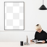 Woman reading a magazine with a blank frame on a wall