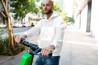 Menswear png hoodie mockup on a man with scooter