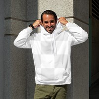 Menswear png hoodie mockup on man with green pants in the city