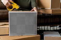 Parcel box transparent mockup png being packed for delivery by a small business owner