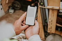 Man holding png smartphone mockup near a construction site