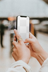 Phone mockup png with blank application being used by a woman at a train station