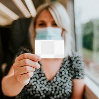 Train ticket png mockup daily pass being shown by a mask-wearing woman