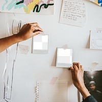 Artist rearranging a mood board for an art and design project 