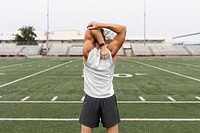 Sports top png mockup on a man warming up by stretching before exercise