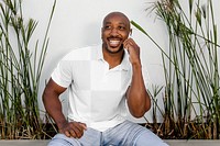 Transparent polo shirt mockup, png apparel worn by happy man on a phone call