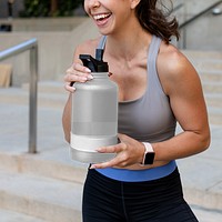 Water bottle png mockup transparent held by an athletic woman, reusable sports accessory 