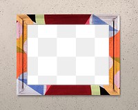 Frame PNG mockup, colorful pattern on beige wall