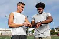 Sports top mockup psd on athlete and coach discussing fitness tracker and performance