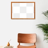 Picture frame mockup hanging above a classic wooden chair