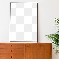 Blank picture frame on a wooden cabinet