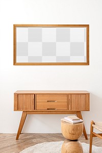 Picture frame mockup above a wooden sideboard table 