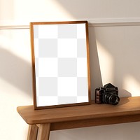 Picture frame mockup on a wooden sideboard table with an analog camera 