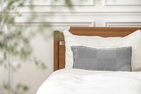 Cushion cover mockup png on a bed