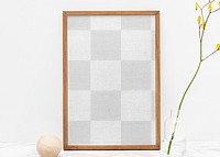 Wooden picture frame png mockup by a yellow forsythia