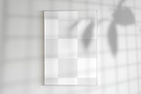 Blank frame on a wall with plant shadow
