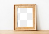 Brown wooden frame png mockup by a wall