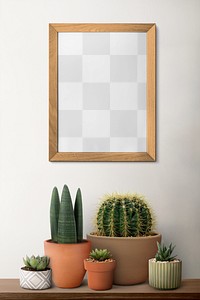 Picture frame png mockup on a shelf with plants against a wall