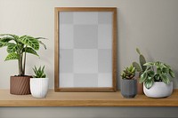 Picture frame png mockup on a shelf with plants against a wall