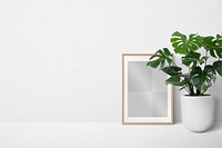 Picture frame png mockup against a wall