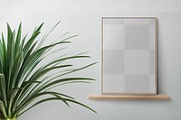 Minimal picture frame png mockup on a shelf against a wall