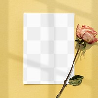 Blank paper with dried rose on a yellow background design element