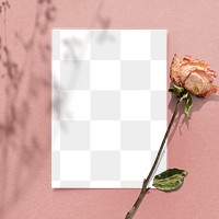 Blank paper with dried rose on a pink background design element