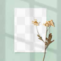 Blank paper with dried flower on a green background design element