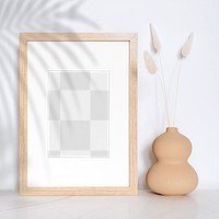 Empty wooden frame with dried flowers in a gourd vase design element